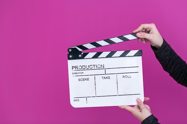 Video production movie clapper cinema action and cut concept\
isolated on pink purple violet background