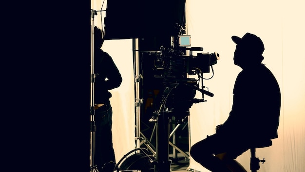 Photo video production behind the scenes which film crew team in silhouette shooting or recording tv movie