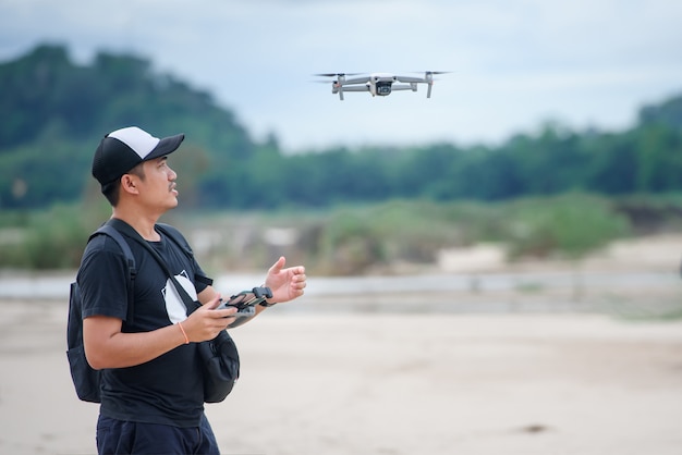 Video recording with a drone plane Asian men using video drones to make music videos