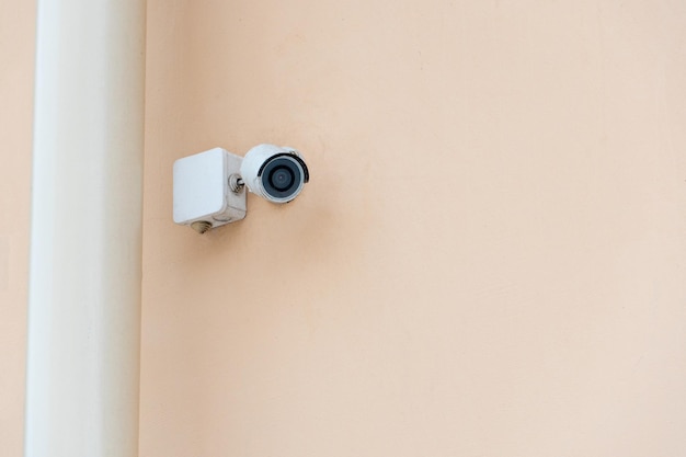 Video surveillance systems Security systems and protection from theft Security CCTV camera installed on the facade of a residential building Digital technology orange background