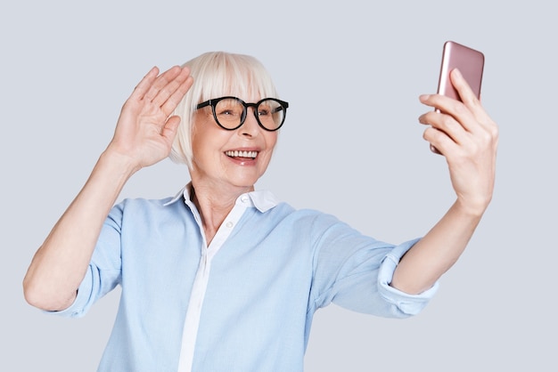 Videoconferentie. Mooie senior vrouw die videogesprek voert en glimlacht