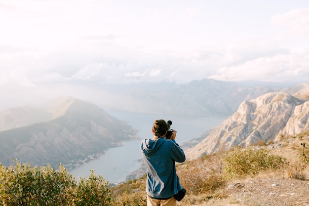 The videographer shoots the video at the mountains