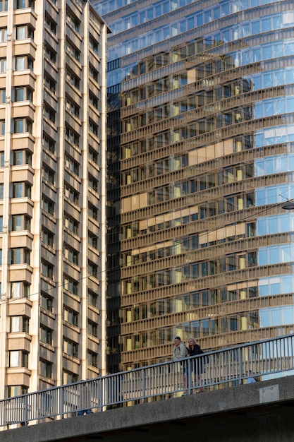 Vienna Austria June 13 2023 A man and a woman on a bridge against the background of highrise buildings