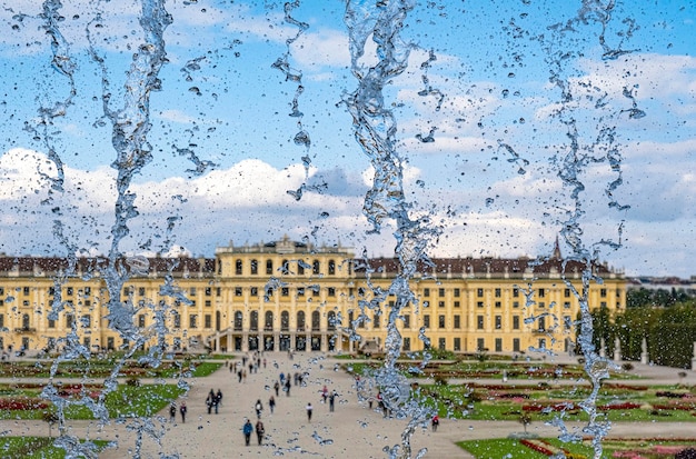 Vienna austria sep 26 2022 schonbrunn palace seen among the water drops of the neptune fountain