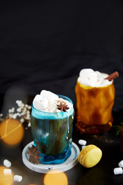 Viennese coffee with macaroons marshmallows cinnamon and cardamom Christmas drinks Bokeh effect