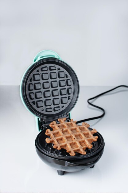 Photo viennese waffle lies in an electric waffle iron copy space