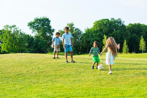 Vier kinderen spelen op avondopen plek.