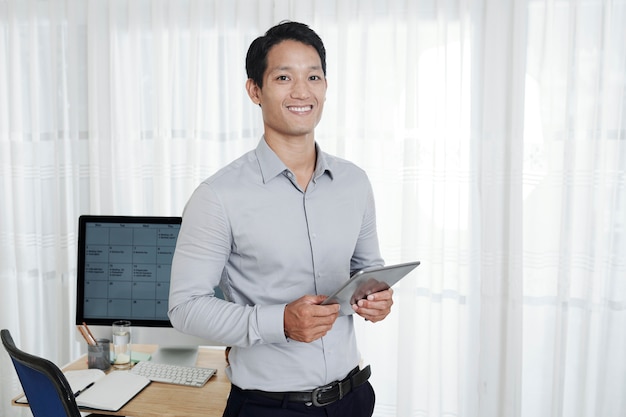 Vietnamese businessman with tablet computer