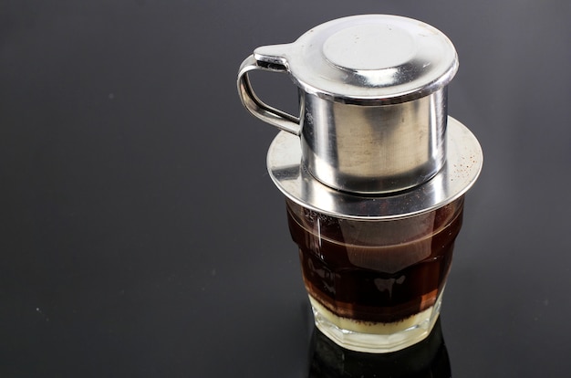 Vietnamese Coffee with Condensed Milk in Glass Cups and Traditional Metal Coffee Maker Phin. Traditional Method of Making of Vietnamese Coffee Drip. Space for Text. Or Advertisement