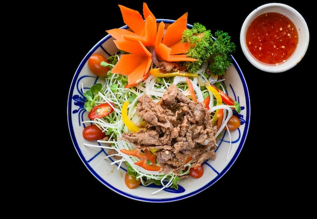 Vietnamese fried beef with salad and sauce on black background for a menu