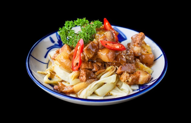 Vietnamese fried pork with ginger on black background