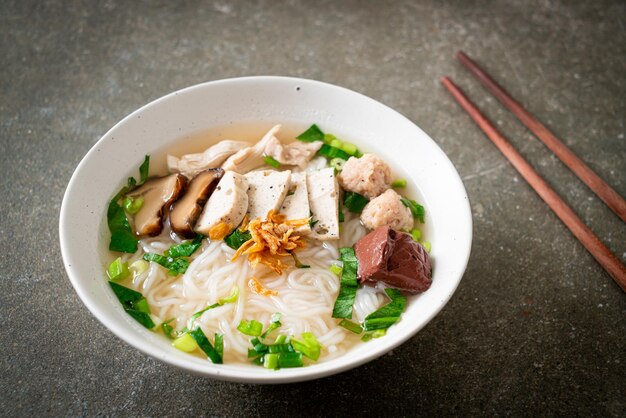 Vietnamese Rice Noodles Soup with Vietnamese Sausage served vegetables and crispy onion - Asian food style