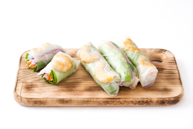 Vietnamese rolls with vegetables, rice noodles and prawns with sweet chili sauce on white surface