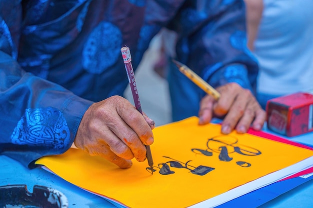 Vietnamese scholar writes calligraphy calligraphy festival is a popular tradition during tet holiday writing couplets for spring festival new year