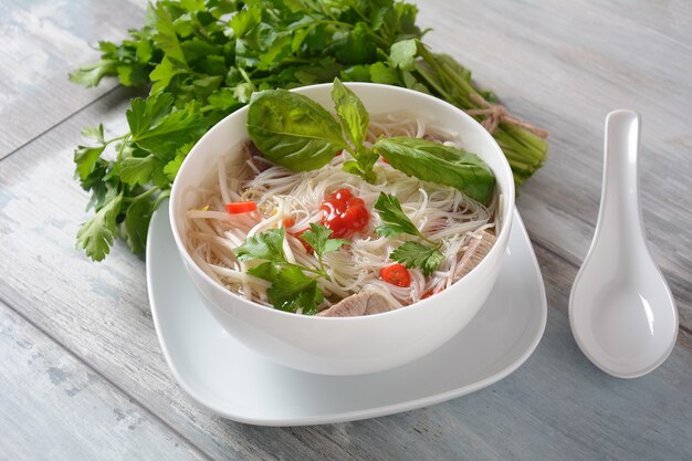 Vietnamese soep Pho bo met kruiden, rundvlees, rijstnoedels, chili en taugé