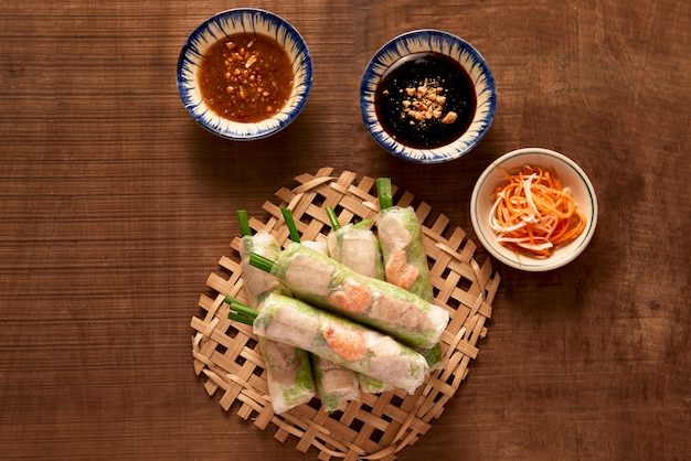 Vietnamese spring rolls - rice paper, lettuce, salad, vermicelli, noodles, shrimps, fish sauce, sweet chili, soy, lemon, veletables. Copy space. Asian and Vietnam food. Traditional national cuisine