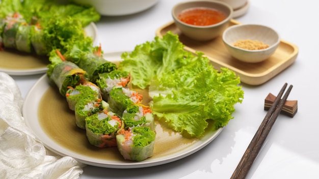 Vietnamese spring rolls with dipping sauce and chopstick on dinning table