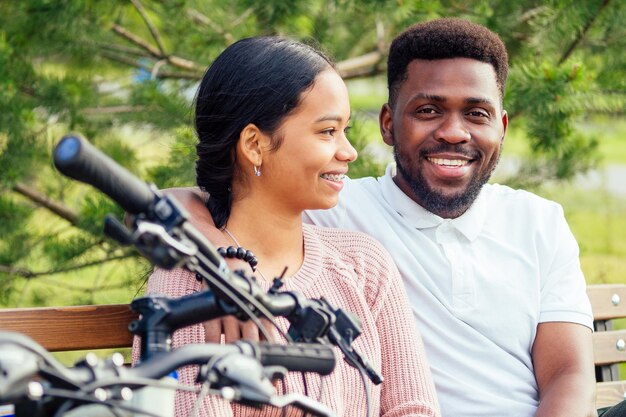 Vietnamese woman and african american man taking a bike for rent