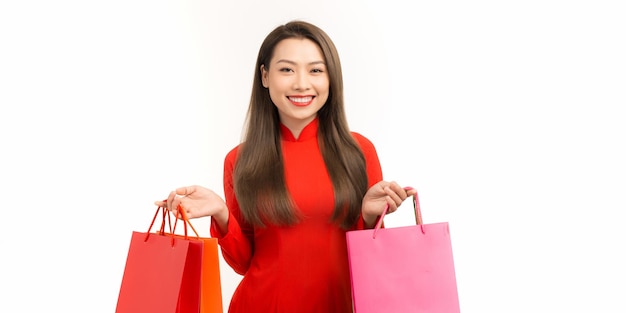 Vietnamese woman with ao dai and hold shopping bag