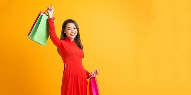 Vietnamese woman with ao dai and hold shopping bag