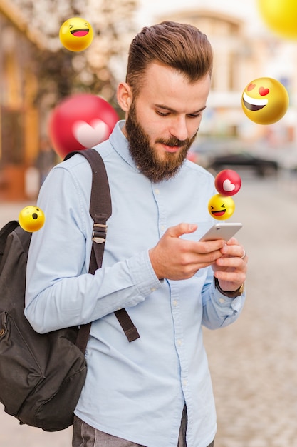 View of 3d emoticons coming out of the screen of an electronic device