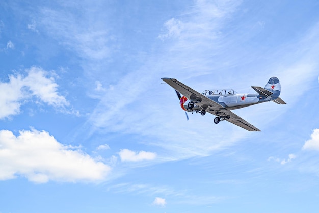 View of an aerobatic plane aerodyne in flight under a blue sky with white clouds flight exhibiti