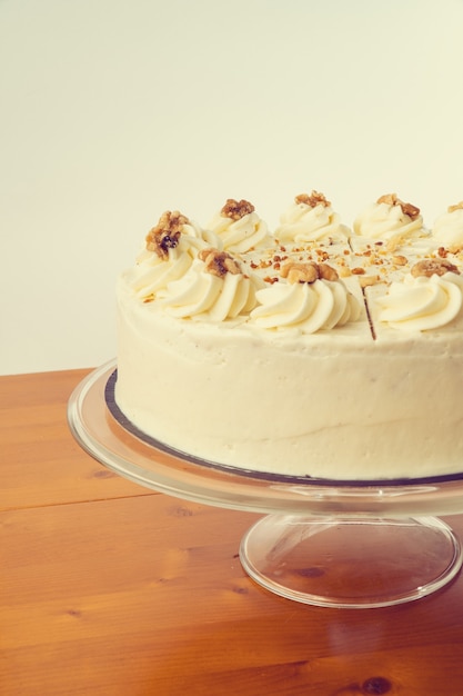 View of an almond and vanilla cake on a white wall