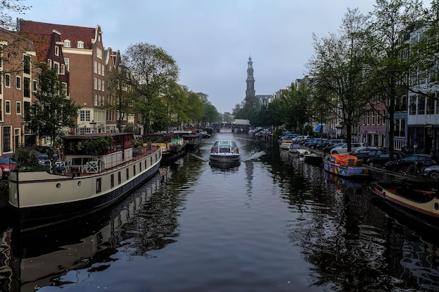 A view along Prinsengracht canal towards the Westerkerk church in morning Amsterdam September 2017