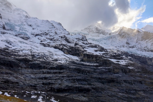 View of alp mountain in autumn have snow on top hill