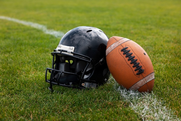 Photo view of american football ball with helmet