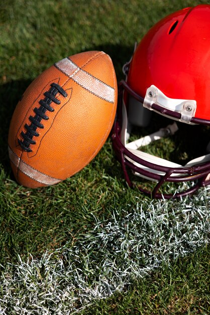 Photo view of american football ball with helmet