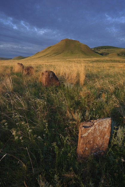 View of ancient burial mounds and menhirs in steppes and mountains of Khakassia