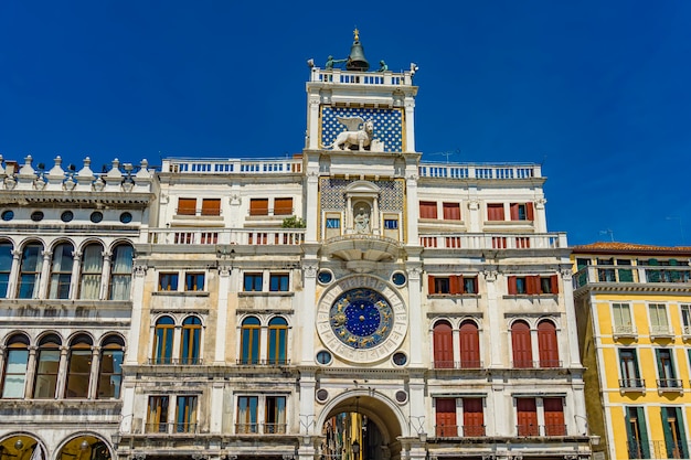 View at ancient clock Torre dell'Orologio in San Marco Square in Venice, Italy