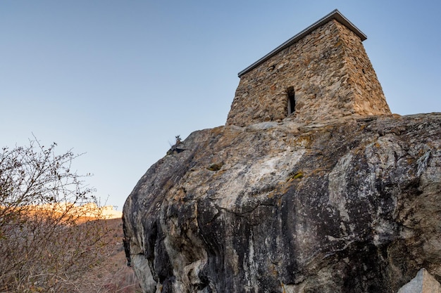 View of ancient stone Tower Fortress Amirkhan-Kala in Kabardino-Balkaria, Russia on autumn day