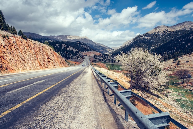 View of a asphalt road that video to the mountains