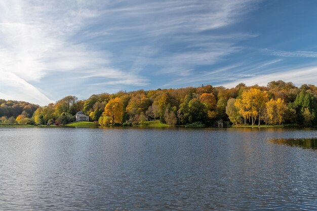 View of the autumn colours around the lake at stourhead gardens in wiltshire