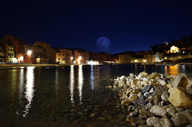 View of the Baia del Silenzio beach at night with spectacular lights and reflections