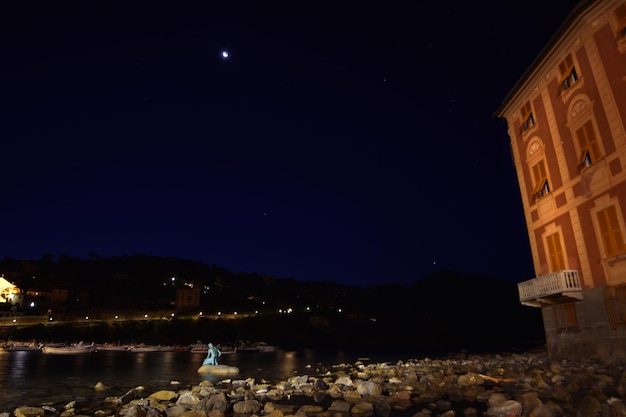 View of the Baia del Silenzio beach at night with spectacular lights and reflections