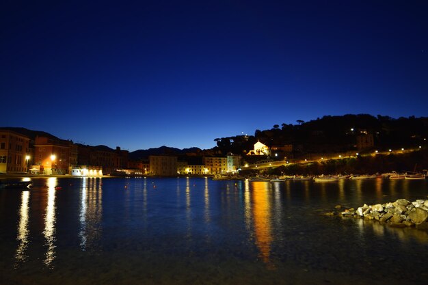 view of the baia del silenzio beach at night with spectacular lights and reflections