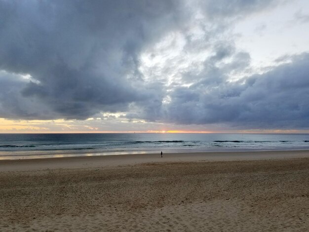 View of beach against cloudy sky