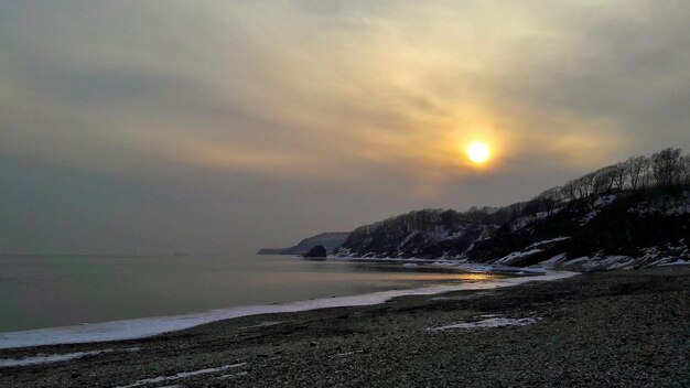 View of beach against cloudy sky