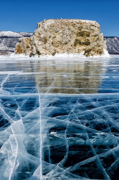 View of beautiful drawings on ice from cracks and bubbles of deep gas on surface of Baikal lake in winter, Russia