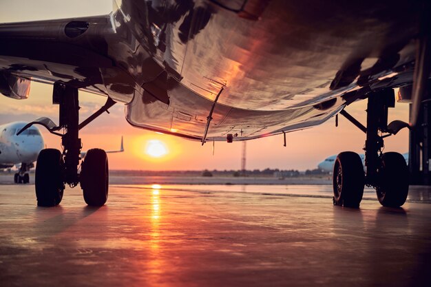 View of big passenger airplane in the aviation hangar in the evening