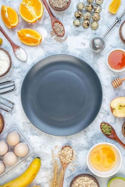 Above view of black plate and ingredients for the healthy food set on ice background