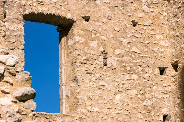 View of blue sky outside a window of 12th century french castle ruins