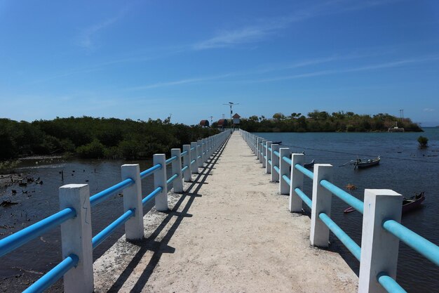 View of boardwalk against blue sky