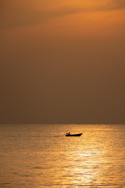 View of boat floating over the sea with sunrise 