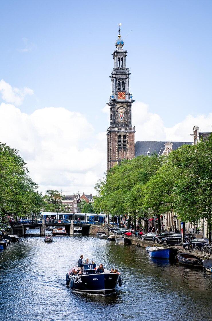 Photo view of boats in canal against cloudy sky