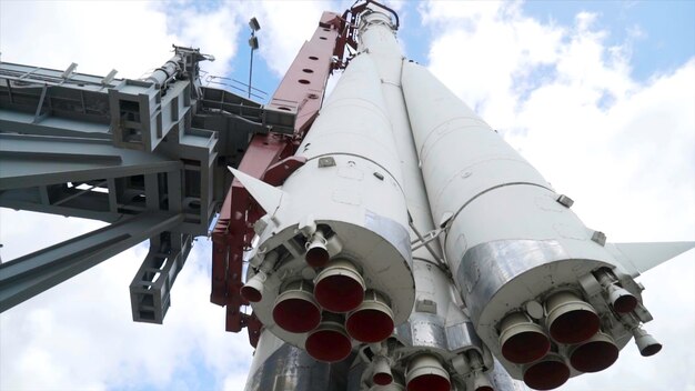 View of bottom of rocket on background of sky action realistic monument of white vostok rocket with