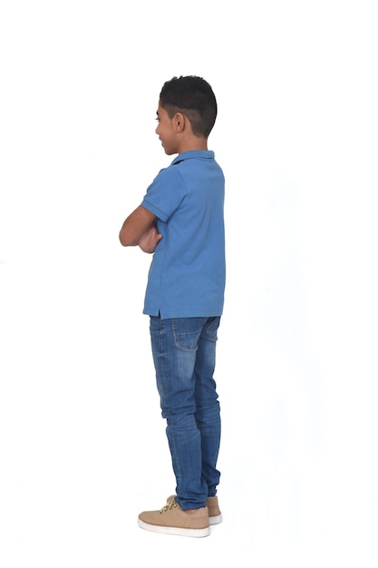 View of boy smiling and arms crossed on white background